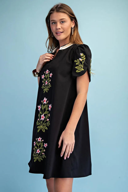 black mini dress with embroided flower